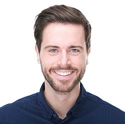 St. Louis Facials model  in blue shirt against white background.