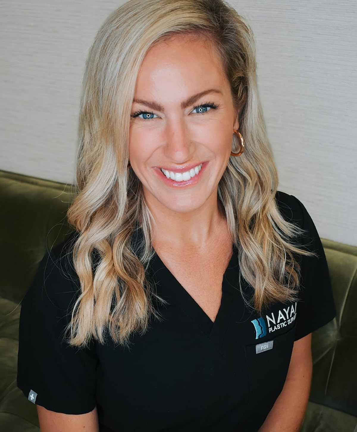 Smiling woman in professional attire, ready for work.