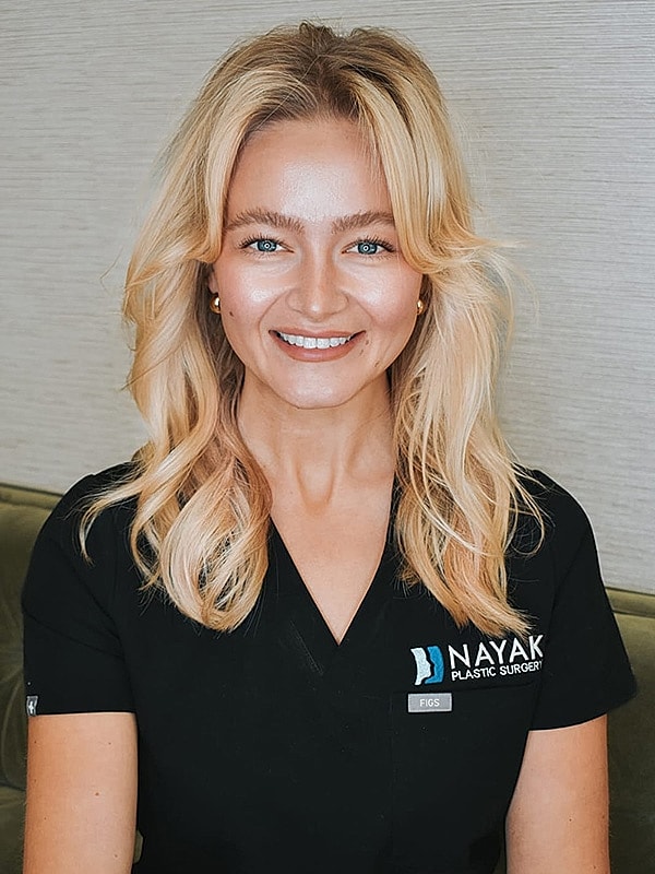 Smiling healthcare professional in medical attire.