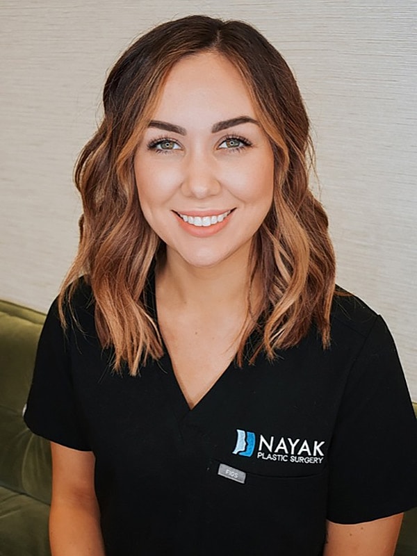 Smiling professional at Nayak Plastic Surgery.