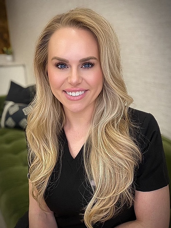 Smiling woman with long blonde hair.