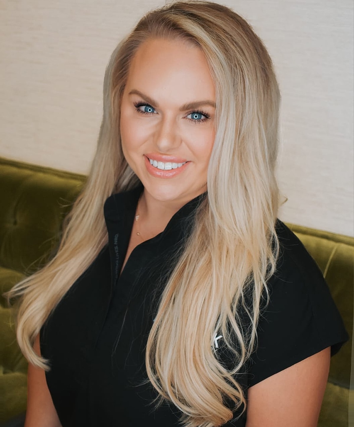 Smiling woman with long blonde hair.