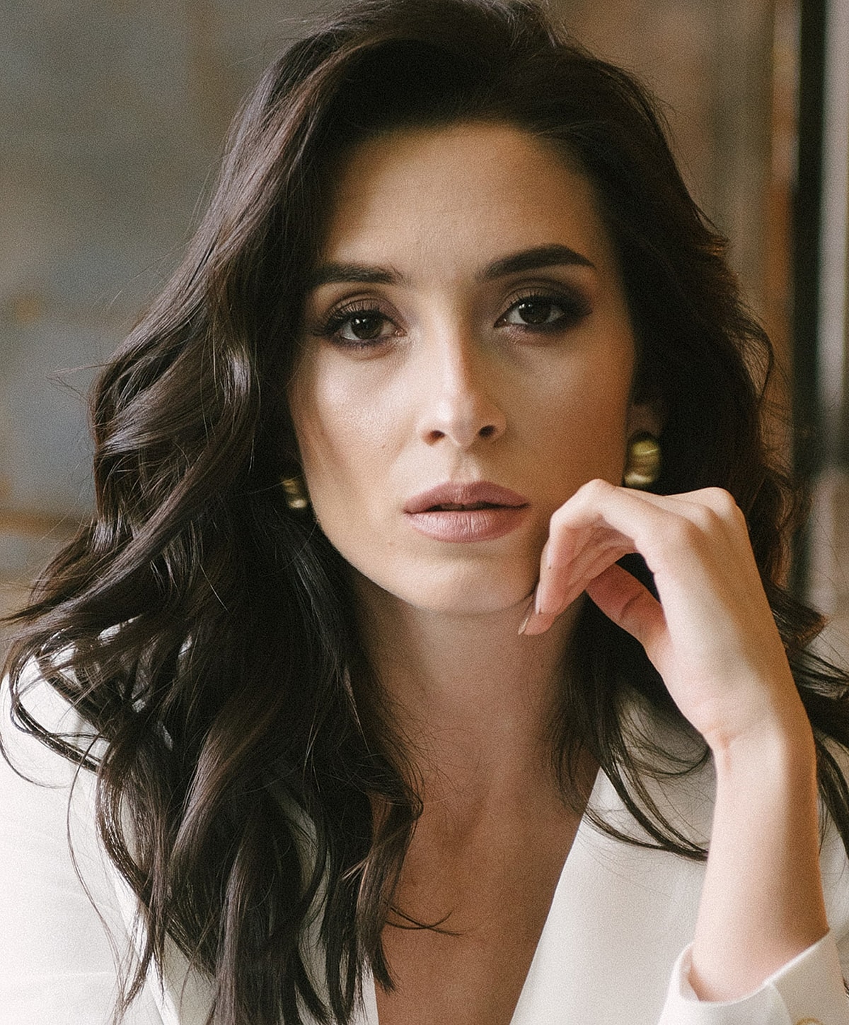 St. Louis injectables model with dark, wavy hair.