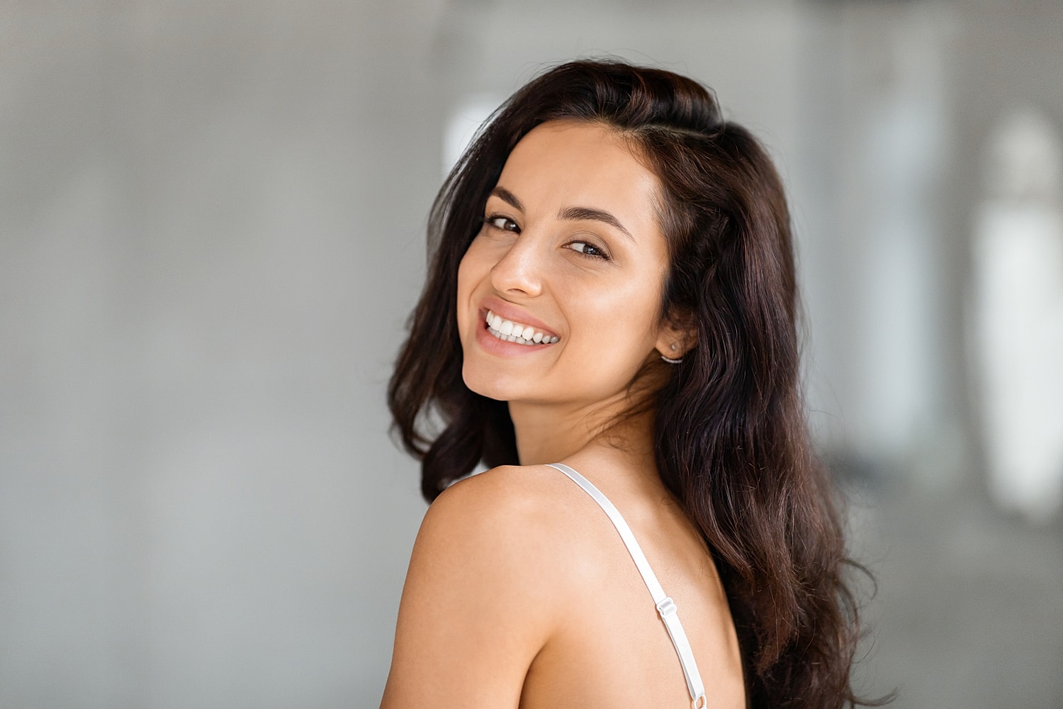 St. Louis facials model with long, dark hair.