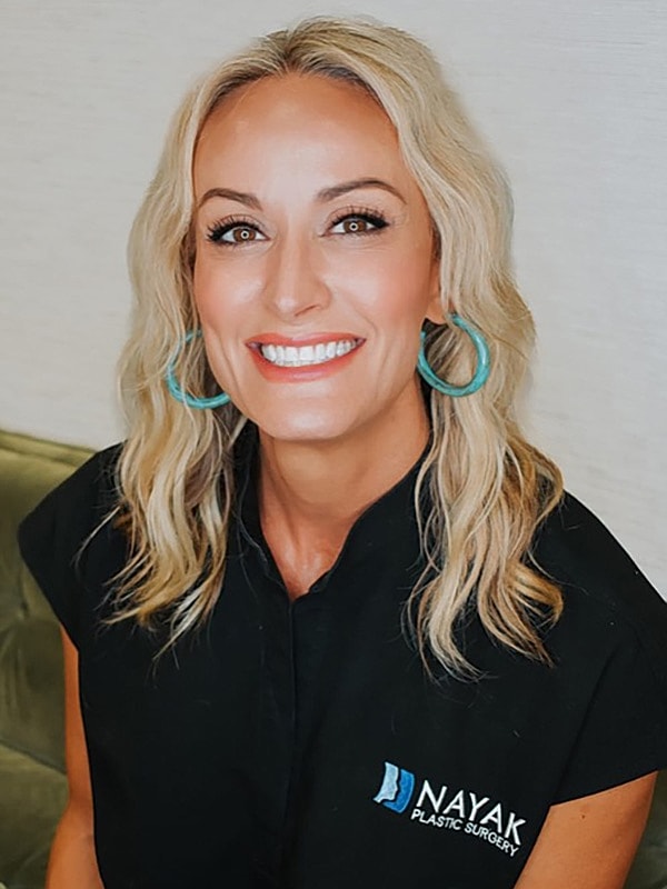 Smiling woman in a plastic surgery clinic.