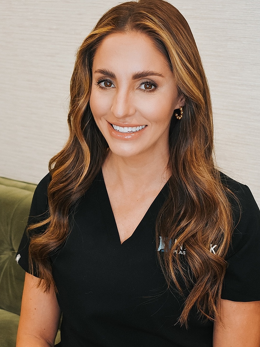 Smiling professional in medical attire.