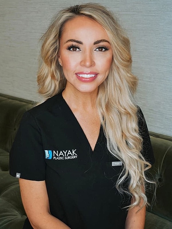 Healthcare professional in plastic surgery attire.