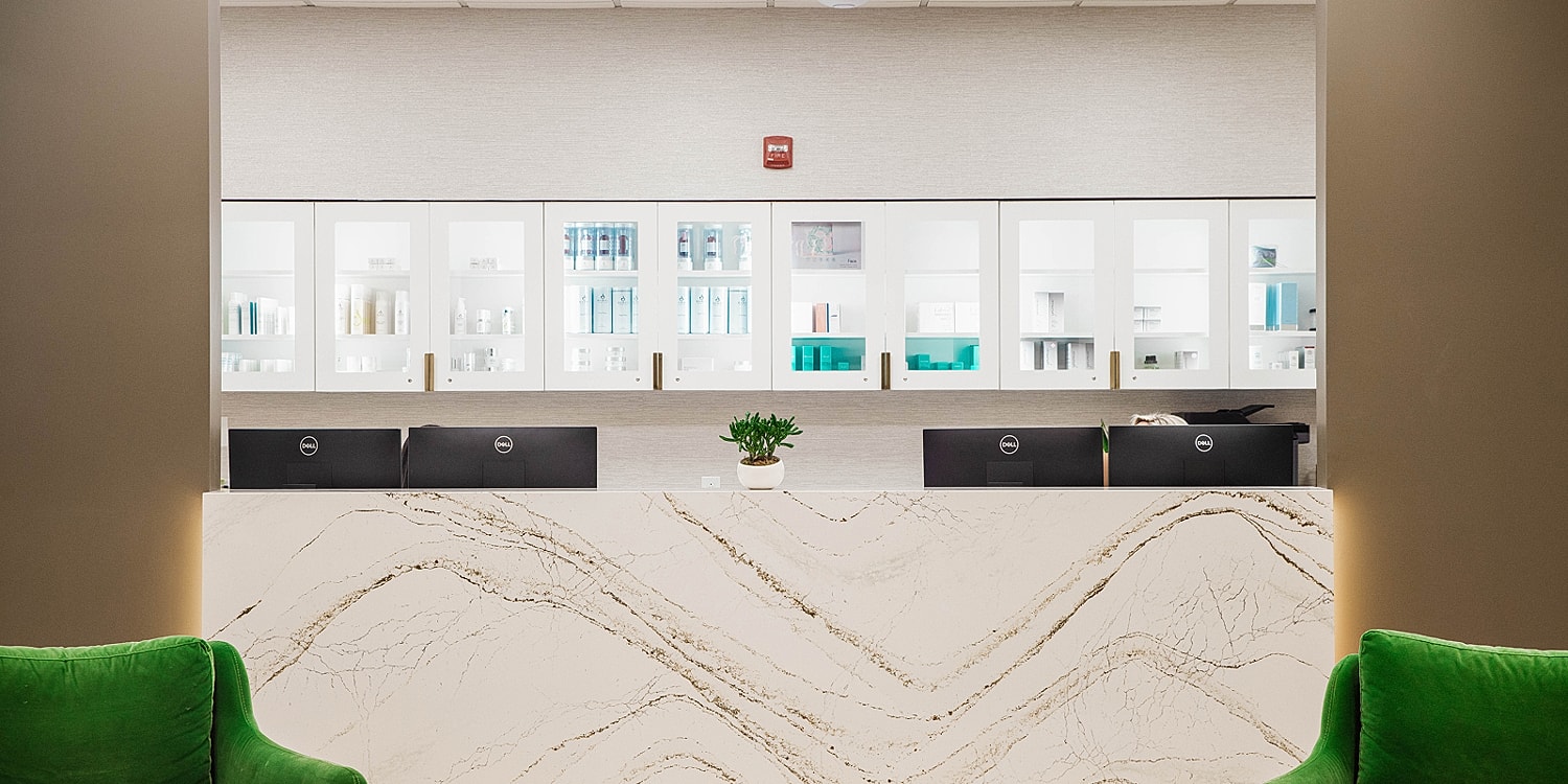 Reception area with skincare products and decor.