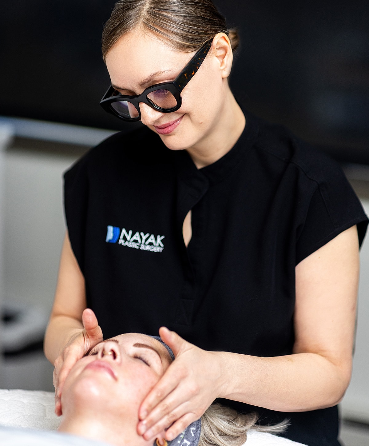 St. Louis CoolPeel professional giving facial treatment to client.