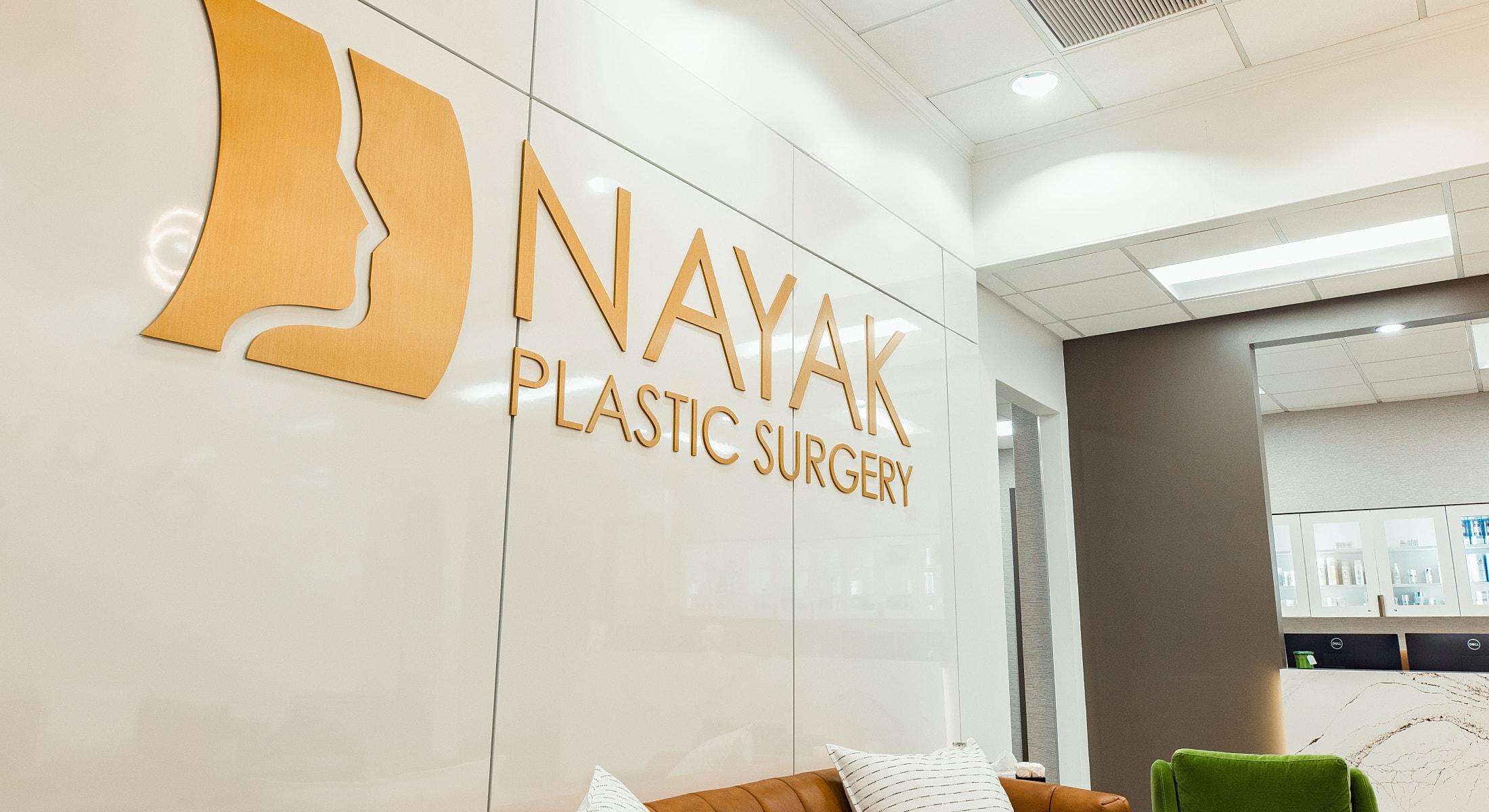 Nayak Plastic Surgery office interior with logo.