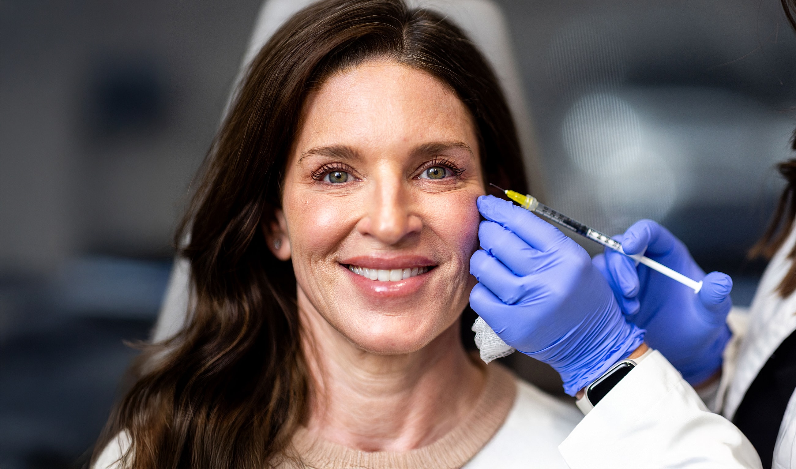 St. Louis Med Spa model receiving facial treatment with a syringe.