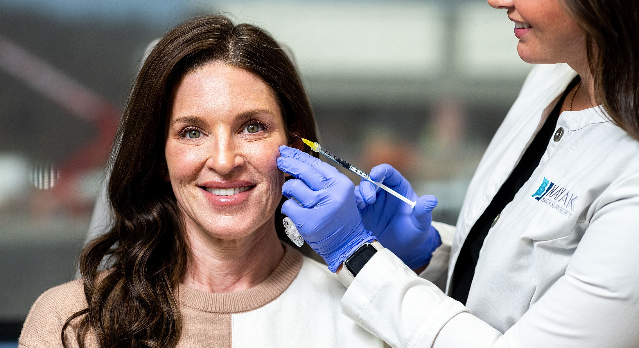 St. Louis Juvederm Ultra model receiving cosmetic injection from healthcare professional.