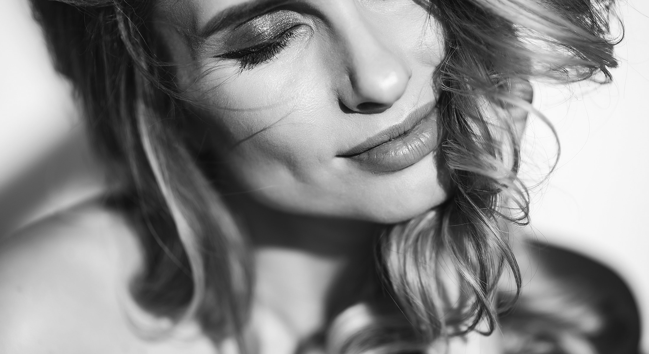 Black and white portrait of a smiling woman.